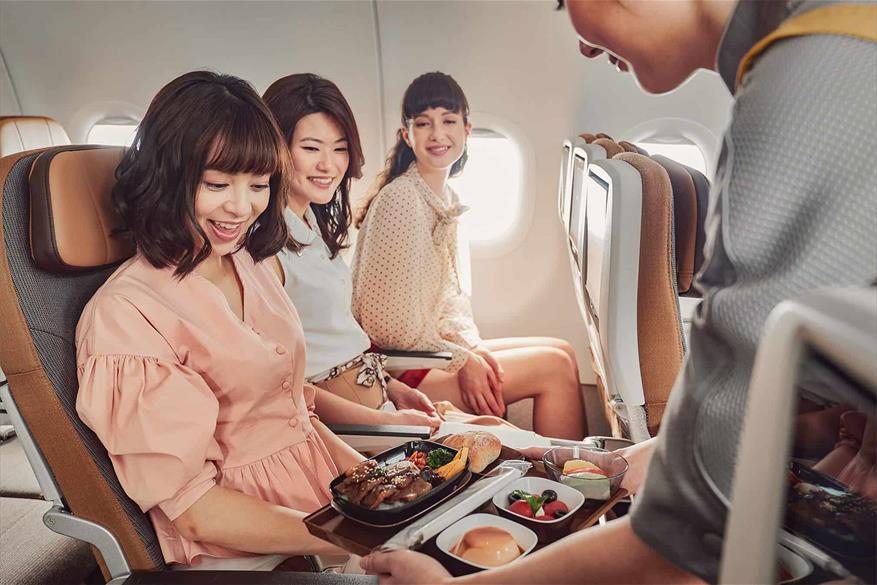 STARLUX Airlines economy class meal services picture. The flight attendant is introducing the Hutong Yakiniku set meal to the passenger.